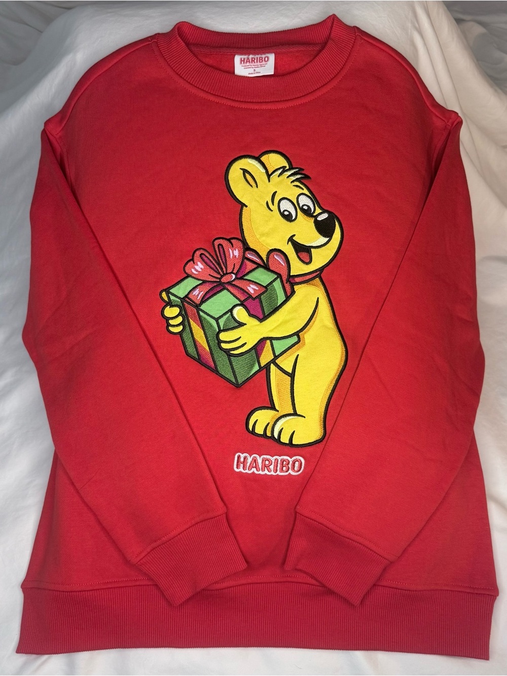 HARIBO Red Sweatshirt with Yellow Bear Holding Green Gift